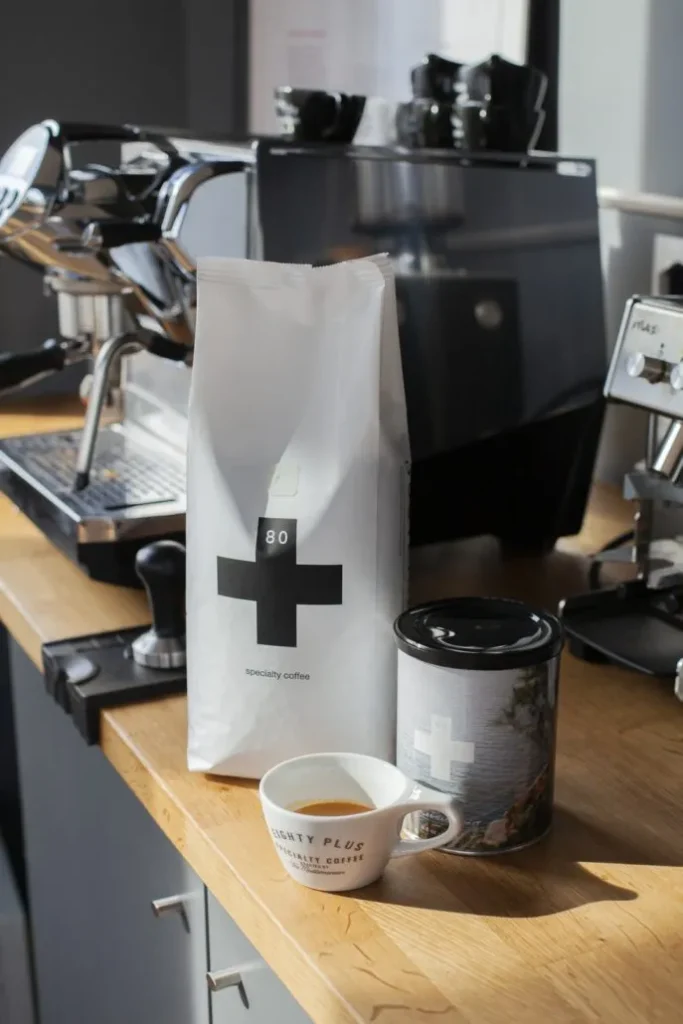 80plus specialty coffee packaging next to an espresso machine