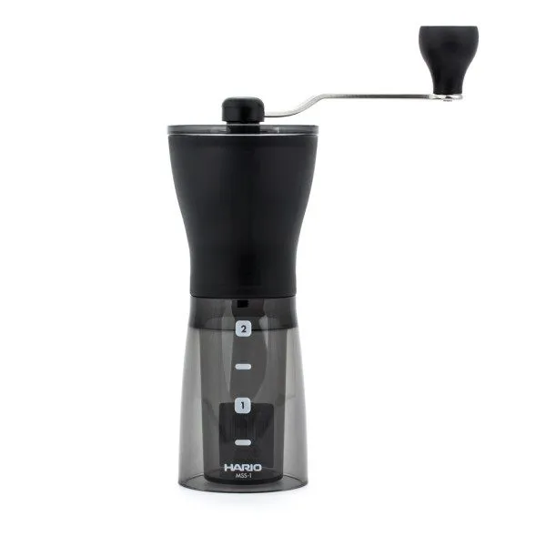 Hario Mini Mill Plus manual coffee grinder with black body, transparent grounds container and hand crank